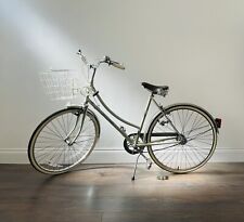 Raleigh Caprice vintage bicycle with basket and leather Brooks saddle.