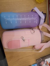 2x 2 litre water bottles 2 straws 1 lid 1 pink carrier