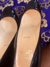 Black heels red bottom shoes