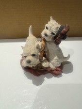 figurine features two West Highland Terrier puppies in a basket, one with a hat