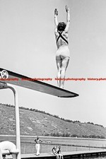 F000497 A young woman on a diving board at an open air swimming pool BdM Germany