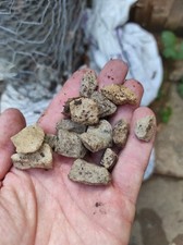 Several half filled bags of driveway stones