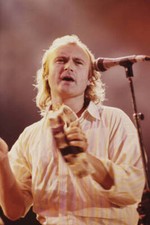 Phil Collins performing on