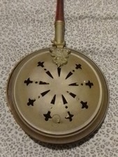 Vintage  bed warmer, also known as a warming pan or a bedpan.