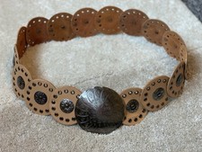 A Western Style Disk Concho Belt Made Of Tan Leather With A Silver Tone Buckle
