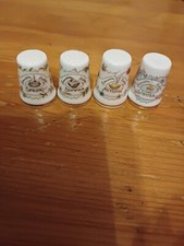 A Set Of 4 China Thimbles