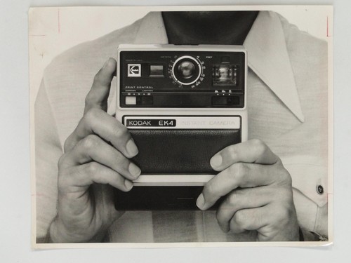 Man holding kodak ek4 - holding, instant