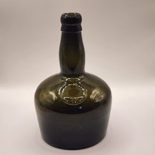 Antique "black" glass mallet bottle, likely used for whiskey or other liquors in