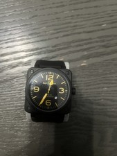 Black And Yellow Bell & Ross Square Face Watch With Rubber Strap.
