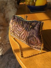 Farfalla sequinned purple evening bag.