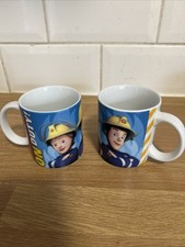 2 cups Fireman Sam  ‘Always On Duty’ by  Kinnerton dated 2011 3.25” X 3”