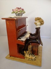 Laura Dunn man playing piano with cat pottery ornament 