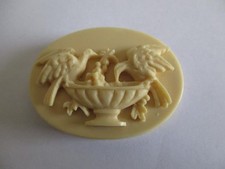 Deeply carved doves pin