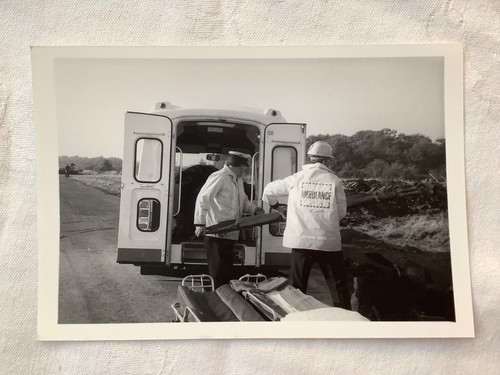 Two ambulance workers carrying