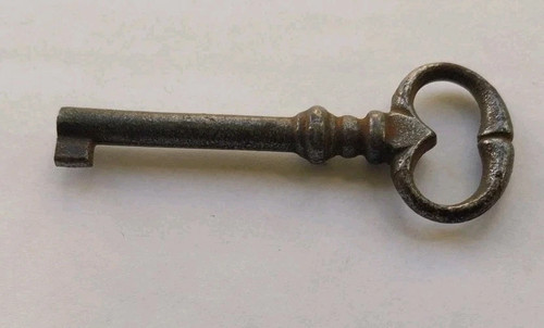 Antique metal key with open