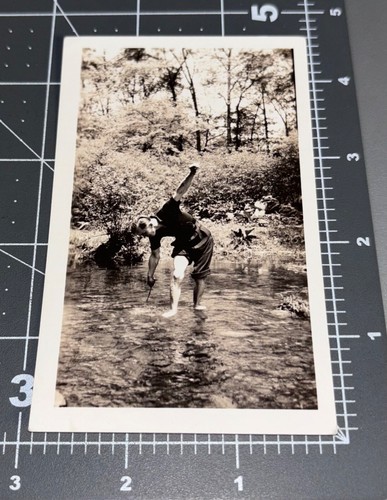 Odd man barefoot feet river - man,