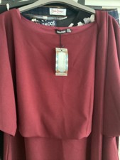 Burgundy coloured dress small ik size 24. Below the knee in length.