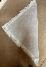 White Shawl with silver thread running through it.