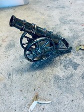 Cannon door stop / ornament, quite heavy with a metallic finish.