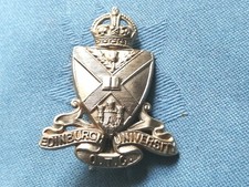 The Edinburgh University Officer Training Corp cap badge.