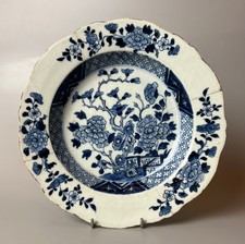 A late 18thc Chinese Export soup bowl painted with a floral and fence design.