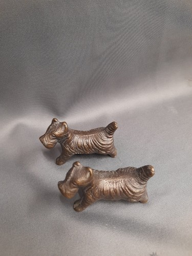 Pair brass cairn terriers - a,