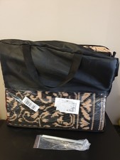 outdoor carpet folded in a black bag with spikes unused cream and black colour