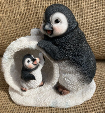 Penguin And Baby In Snowball