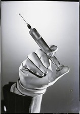 Gloved hand holding - , a