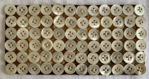 Mother pearl buttons on - of,