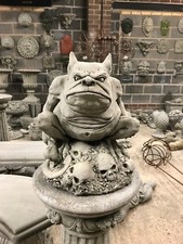 Gargoyle sat on skulls stone