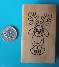 Cute reindeer and bells rubber stamp on wood block