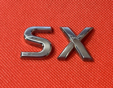 NISSAN "SX"  - CAR BADGE / EMBLEM - WILL REQUIRE NEW ADHESIVE TO REAR