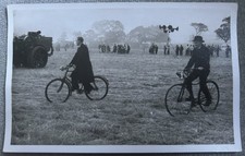 Gents riding old bicycles
