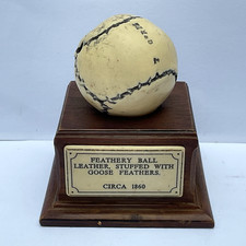 Feathery Ball Golf Ball Paperweight Ornament on a wooden stand with plaque