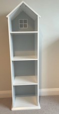 A Shelving Unit That Is The Shape Of A House
