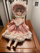 Porcelain doll with pink lacy