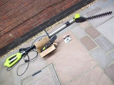 Hedge trimmer with chainsaw attachment