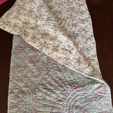 a vintage quilted Cotton Bedspread a patchwork design in green, red and blue