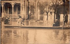 Men in Long Wooden Skiff After