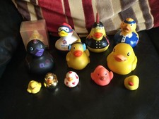 Collection of 12 rubber ducks including John Lewis and Bud ducks