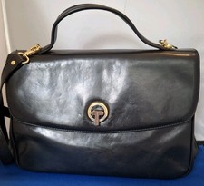 Nadia black leather top handle bag with detachable strap.