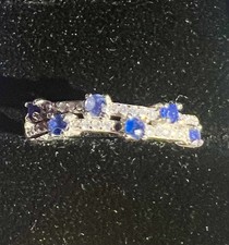 Line of blue tourmaline stones on a silver plated ring band