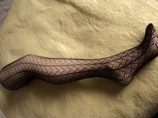 Ladies black patterned tights in plain packaging