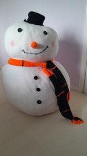 Giant snowman - crocheted in wool and stuffed with foam, wearing an orange scarf