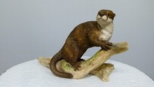 Border fine arts otter on log