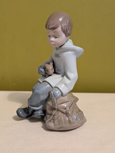Lladro nao boy resting on - :,