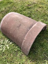 Red clay capped half round ridge tiles
