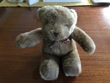 Mothercare Soft Teddy Bear. Light Brown sits 23 cm tall