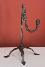 Eighteenth century rushlight holder, supported on four legs,   with "arrow" feet